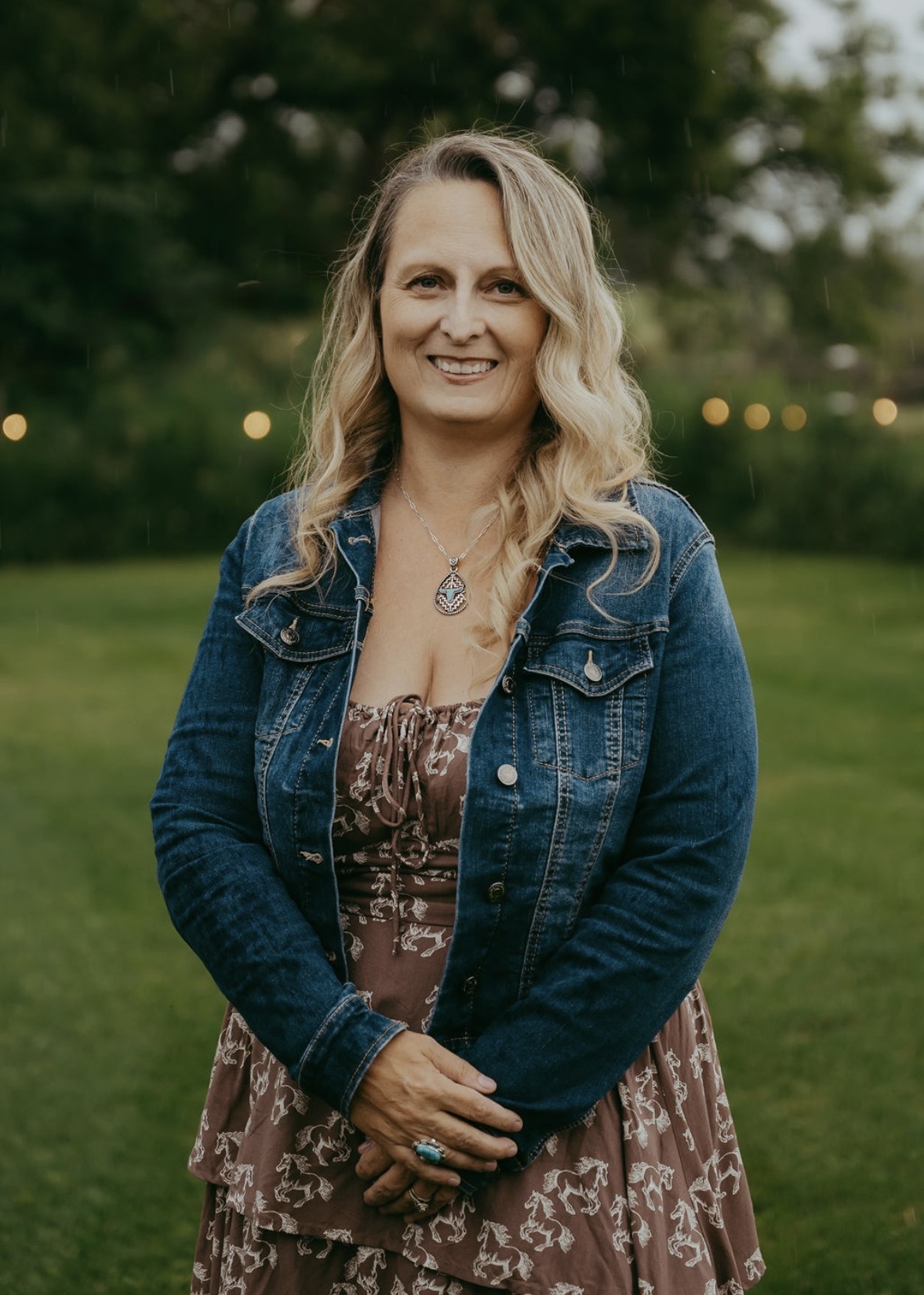 Danielle Baril, end-of-life doula and Registered Nurse, standing outdoors at dusk